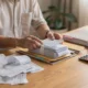 Business owner reviewing bank statements and financial documents at a desk